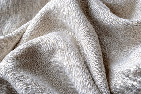 Close-up of beige cotton fabric with visible texture