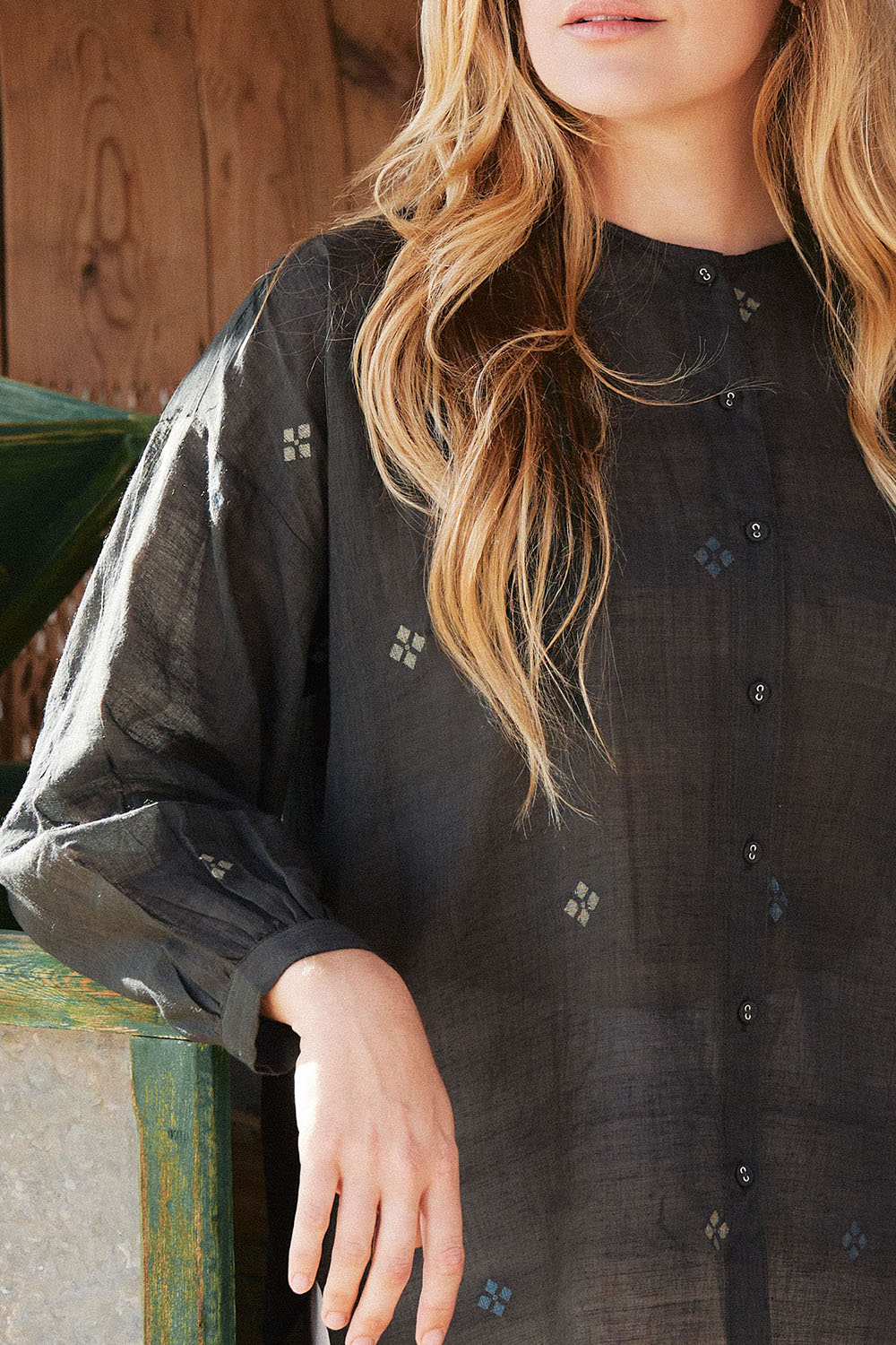 Close-up of model wearing the Midnight Black Oversized Shirt with delicate embroidered motifs and front button detailing.